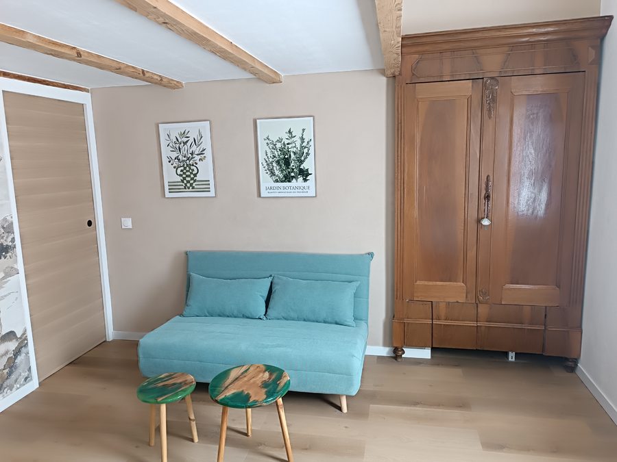 Living area with exposed beams and antique wardrobe